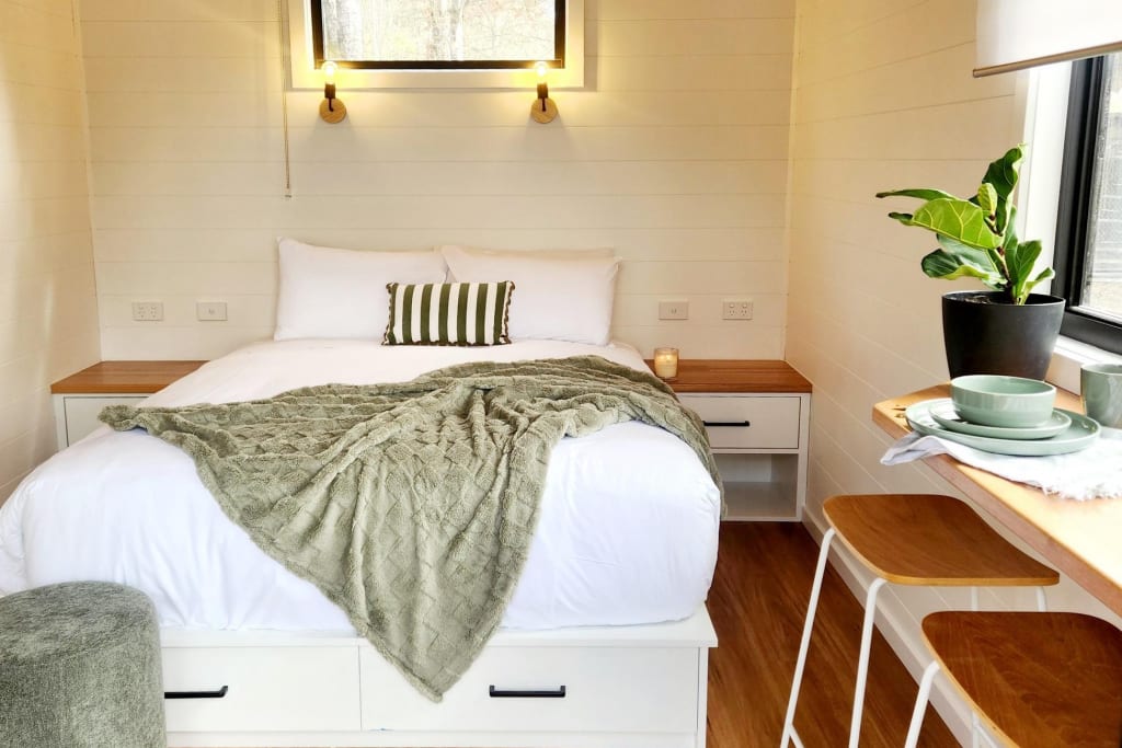 Queen bed with breakfast bar in contemporary pod accommodation at Bright Accommodation Park, Alpine region VIC