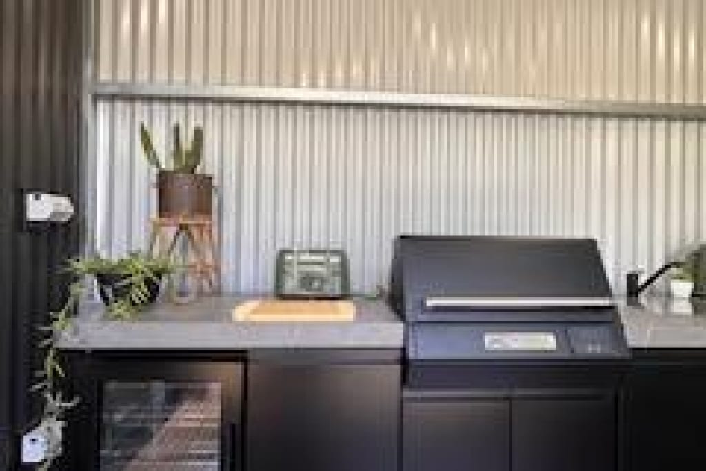 Outdoor BBQ station with bar fridge at Bright Accommodation Park caravan park facilities