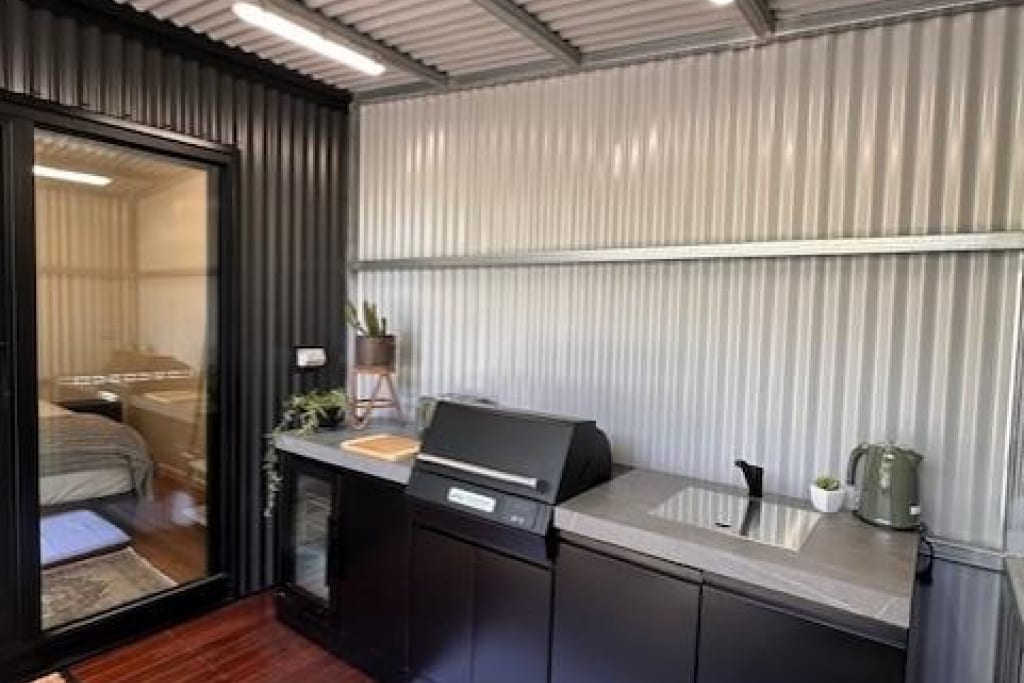 Modern covered BBQ area with gas cooktop and outdoor kitchen at Bright Accommodation Park, Bright VIC