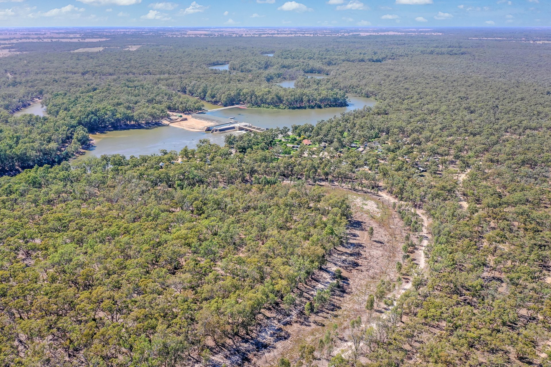 High aerial of murray river bend and gunbower forest canopy at Torrumbarry Weir Holiday Park