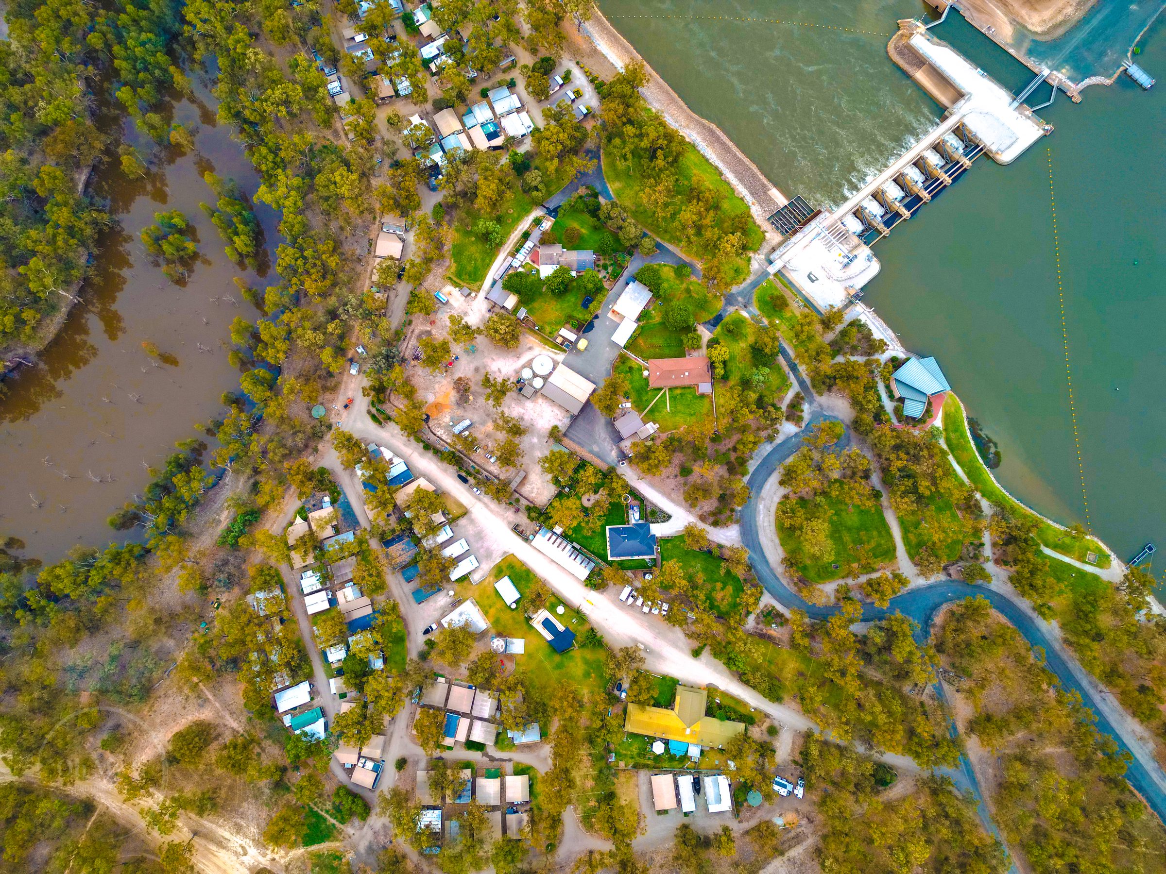 Aerial over park sites looking along the river to the weir at Torrumbarry Weir Holiday Park