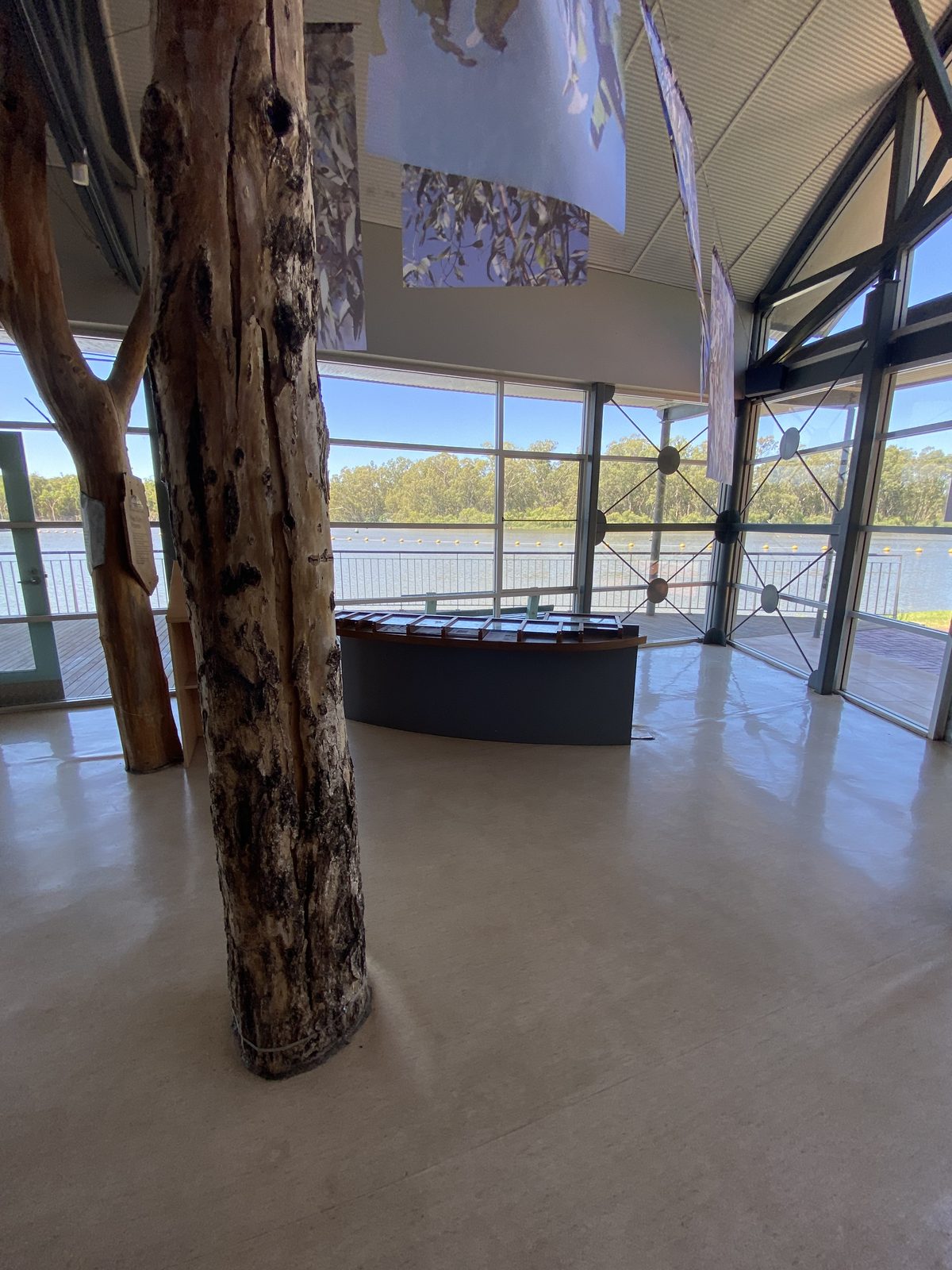 Visitor centre interior with river view through full height glass at Torrumbarry Weir Holiday Park