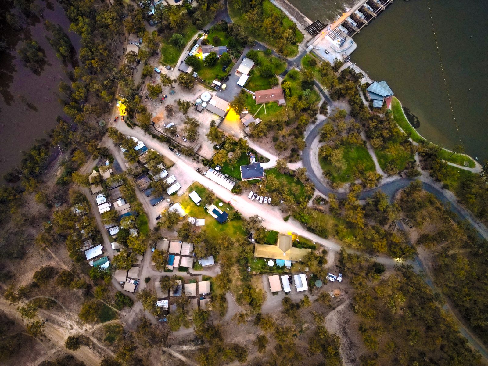Straight down drone view of park cabins roads and sites at Torrumbarry Weir Holiday Park