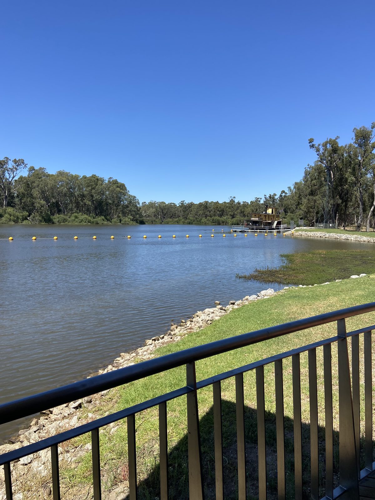 Murray river and stone bank seen from the lookout railing at Torrumbarry Weir Holiday Park