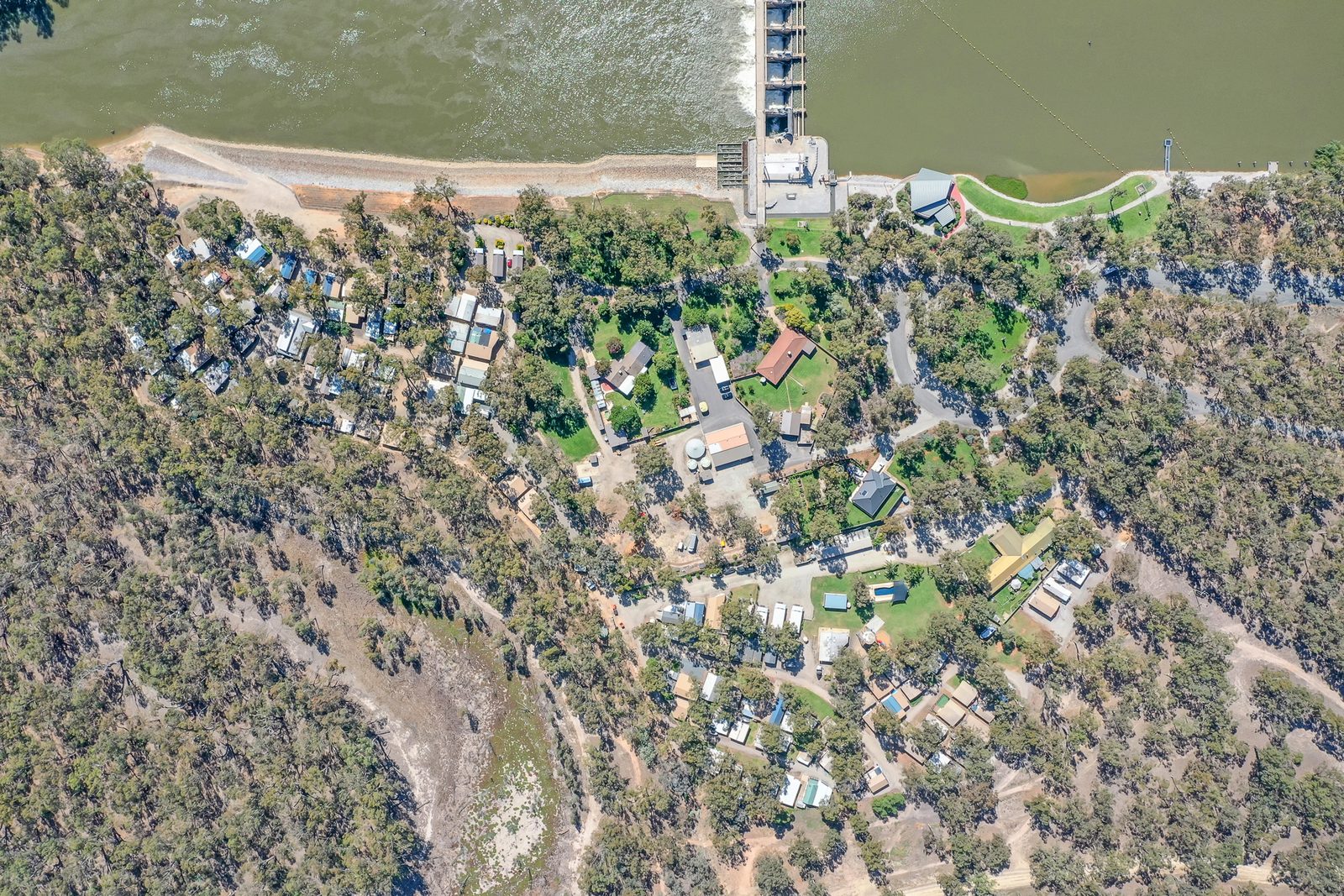 Overhead aerial of park layout cabins roads and shady sites at Torrumbarry Weir Holiday Park