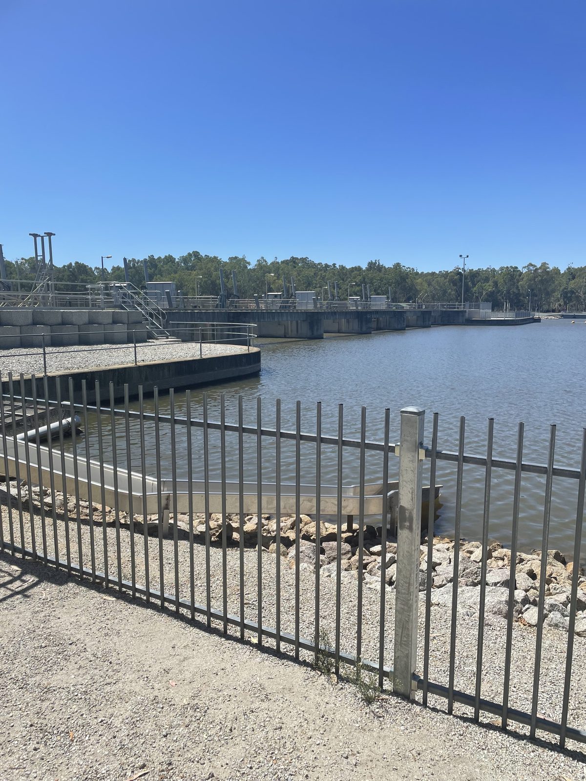 Fenced walkway and viewing platform along torrumbarry weir wall at Torrumbarry Weir Holiday Park