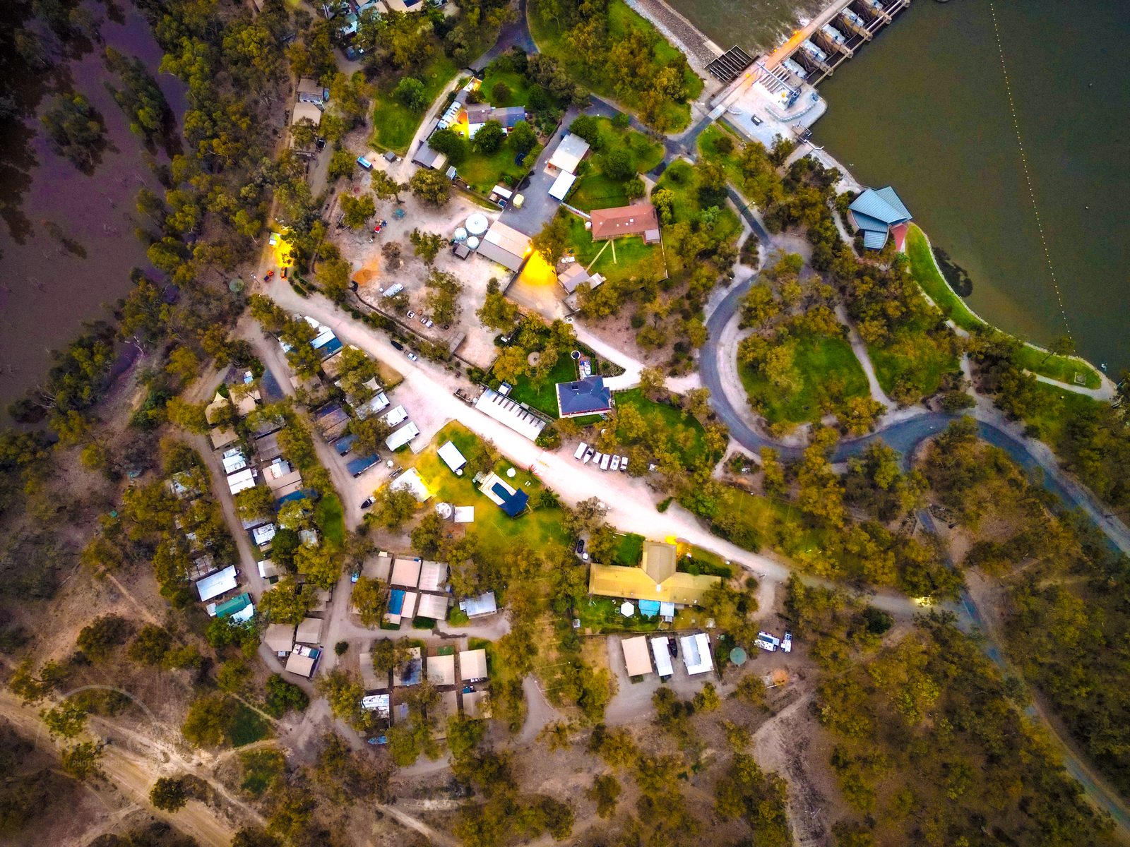 Aerial of cabins caravan sites and internal park roads at Torrumbarry Weir Holiday Park