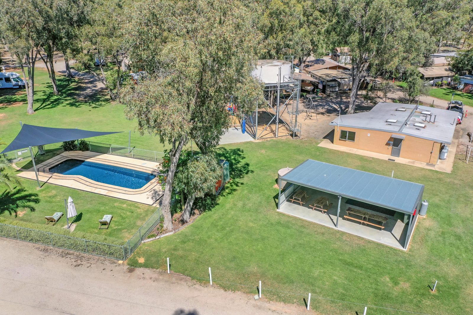 Aerial of swimming pool shade sail cabins and lawn area at Torrumbarry Weir Holiday Park