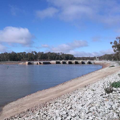 Torrumbarry Weir spanning the Murray River at Patho VIC, viewed from the rocky bank near the caravan park