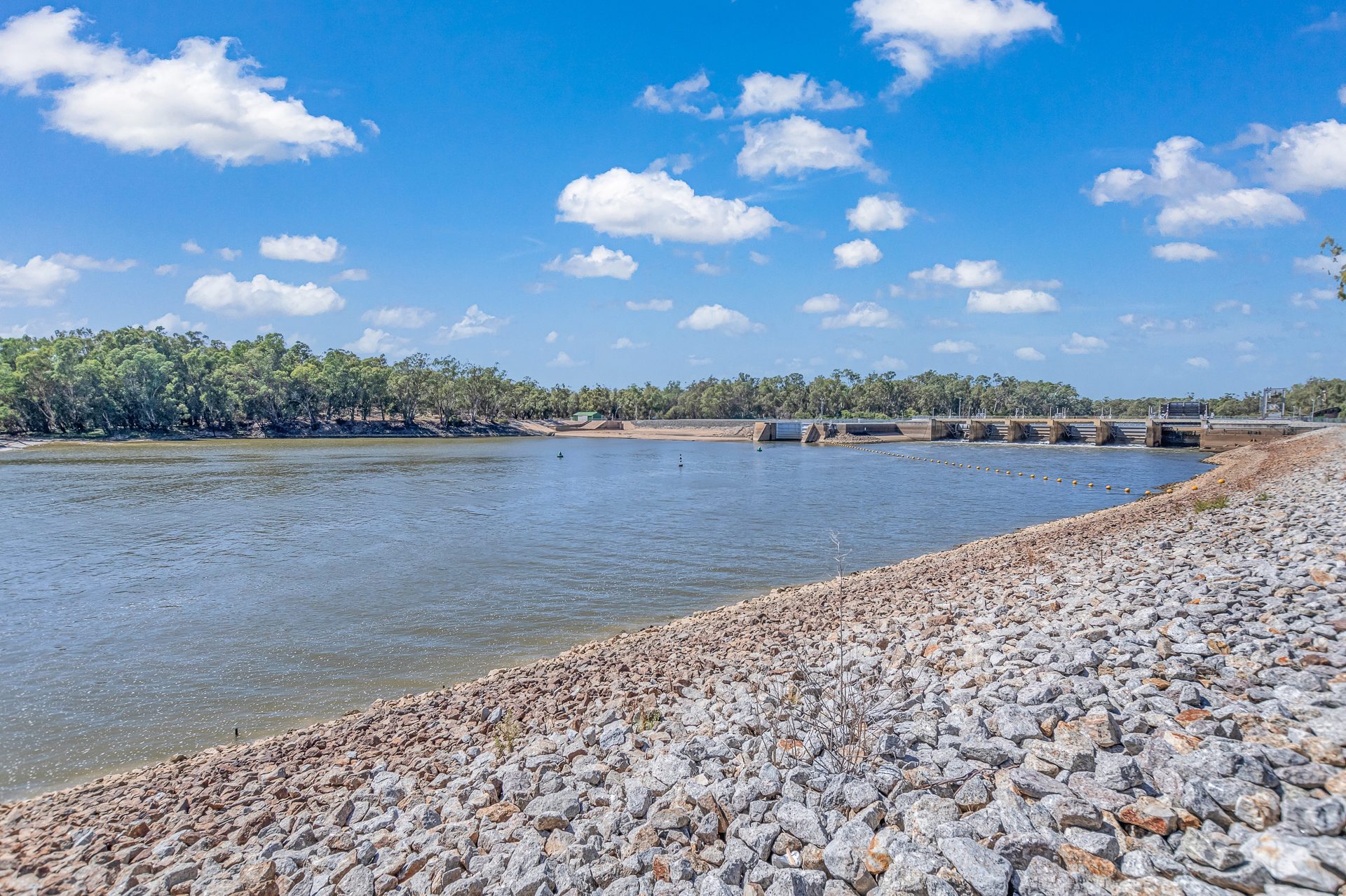 Rock armoured river bank looking downstream to the weir at Torrumbarry Weir Holiday Park