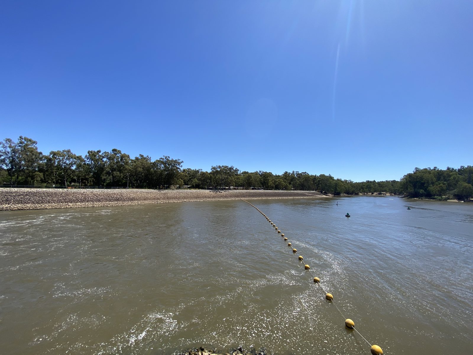 Broad murray river above the weir marked by a yellow buoy line at Torrumbarry Weir Holiday Park
